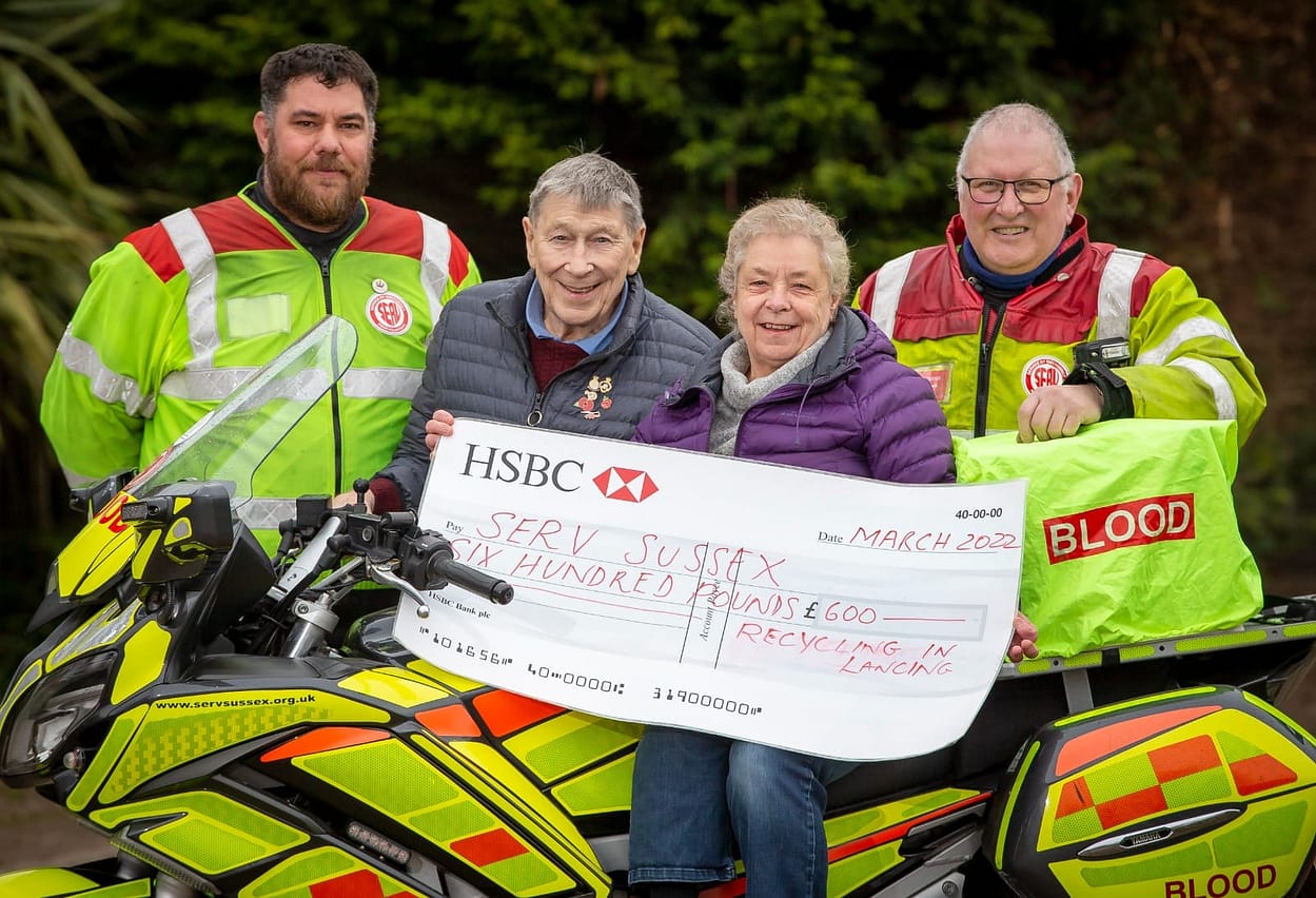 Sue and John Wellfare with a donation to sussex Serv
